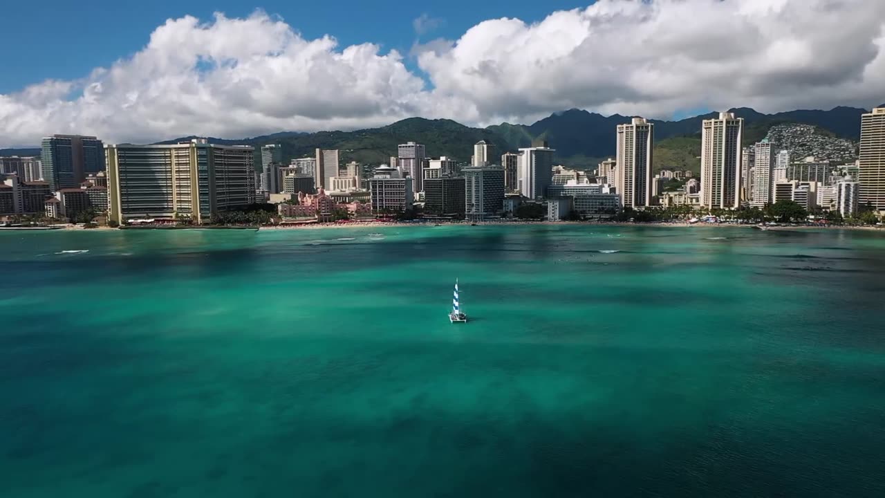 Turquoise water off Waikiki with the Honolulu shoreline in the distance